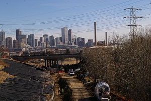 Looking east along the West Corridor LRT construction towards Federal Boulevard with a view of downtown Denver in the background.